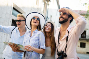 Group of happy young friends hangout on city street